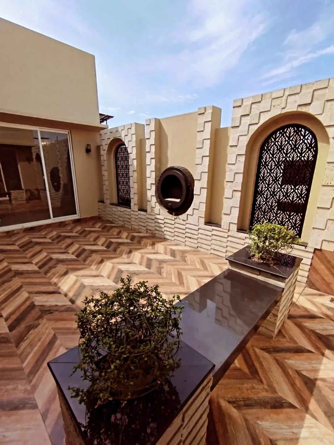 Spacious terrace with herringbone tile flooring and Arabic arch design in 1 Kanal house Block M2 Lake City Lahore