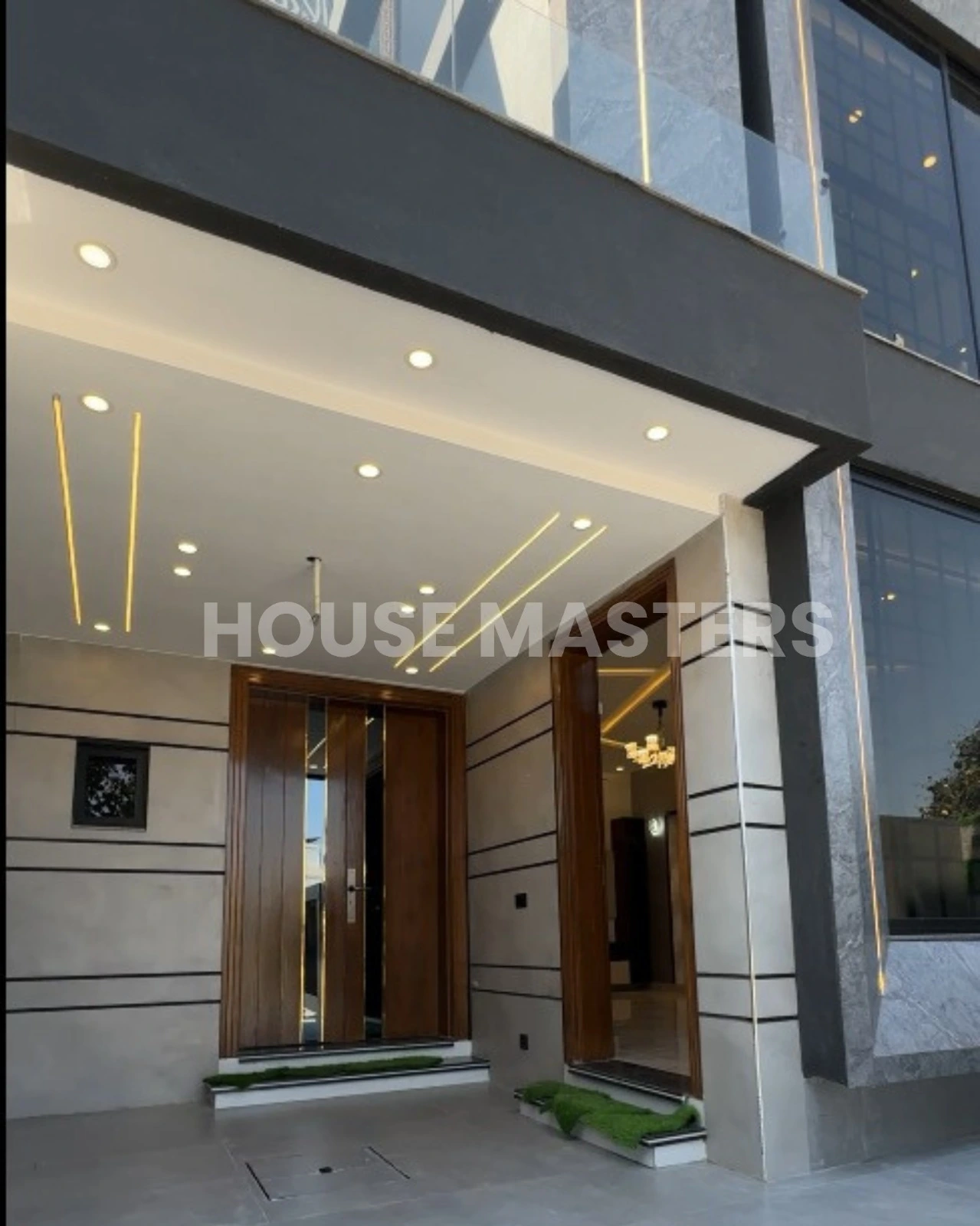Luxury Entrance – 5 Marla House in Bahria Orchard, Lahore Elegant main entrance with modern lighting, wooden doors, and stylish facade in a luxury 5 Marla house in Bahria Orchard, Lahore.