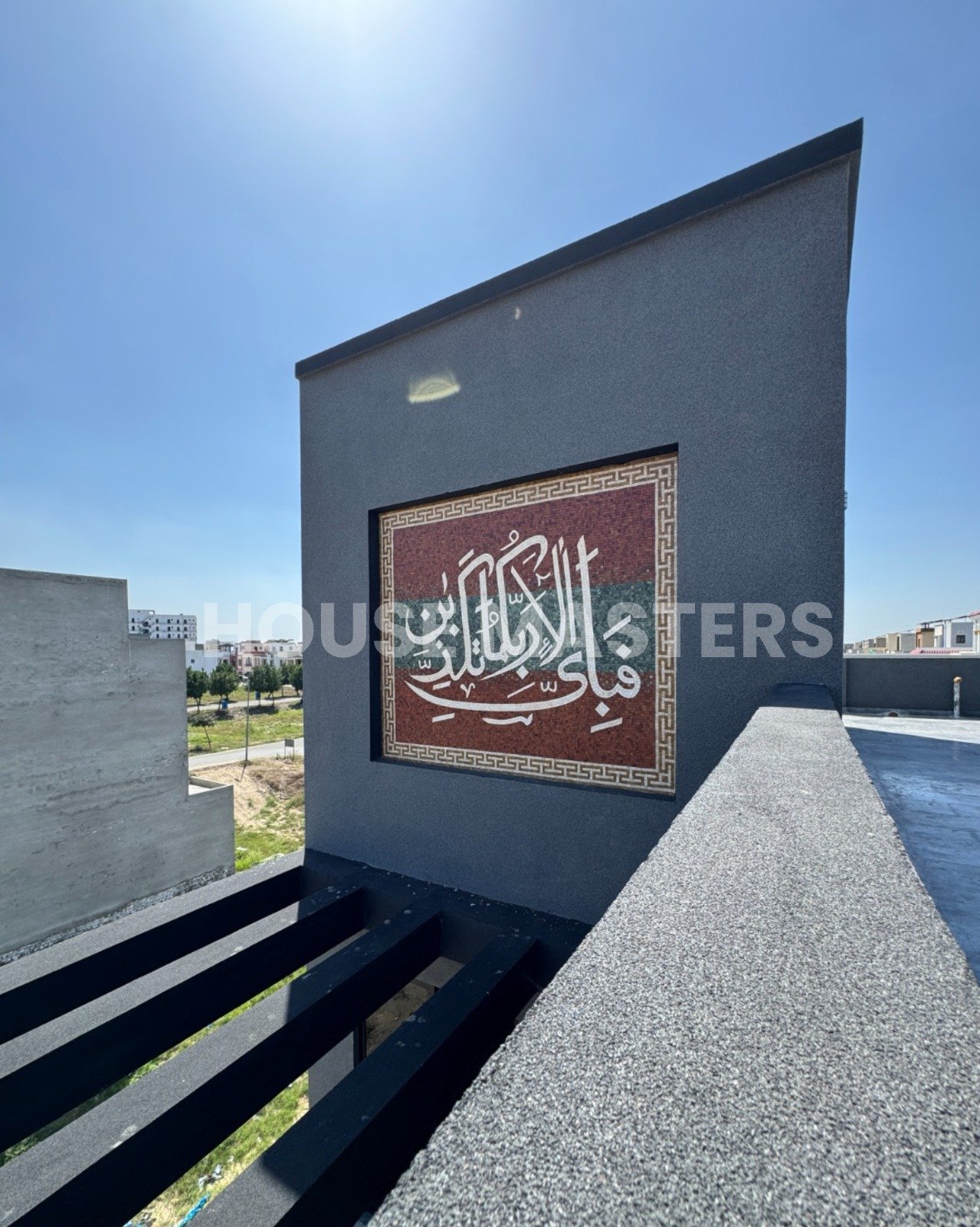 Rooftop Design – 5 Marla House, Bahria Orchard Rooftop area with black beams, modern wall lighting, and scenic view in 5 Marla luxury house, Bahria Orchard.