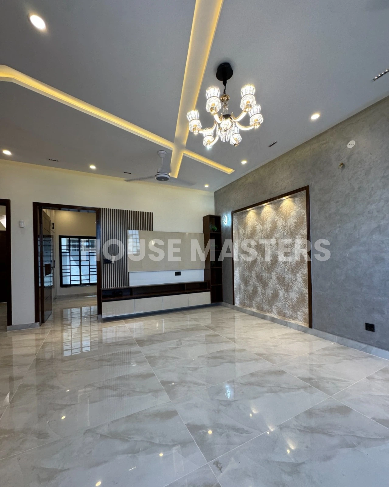 Luxury Living Room – 5 Marla House in Bahria Orchard, Lahore Spacious living room with modern chandelier, luxurious flooring, and contemporary wall design in a premium 5 Marla house in Bahria Orchard, Lahore.